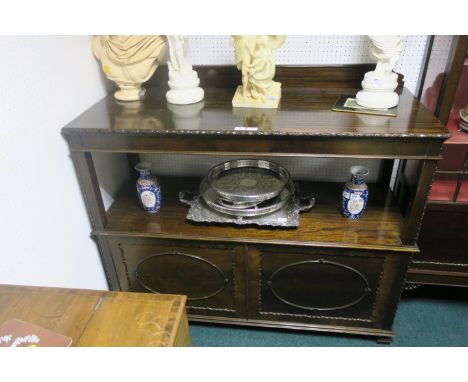 A MAHOGANY DUMB WAITER, 20th CENTURY, the plain top with carved border above single shelf and with panelled doors,  109cms x 