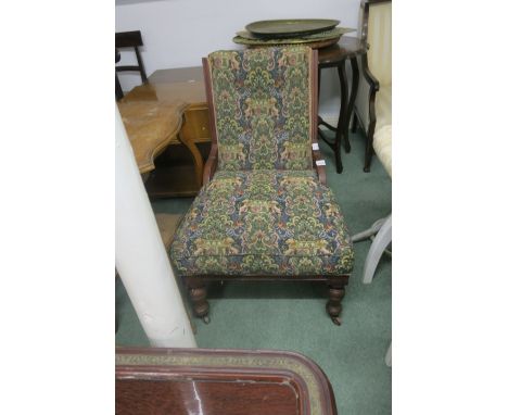 AN EDWARDIAN MAHOGANY FRAMED ARMCHAIR the tapestry upholstered back and seat raised on ring turned supports with castors FIVE
