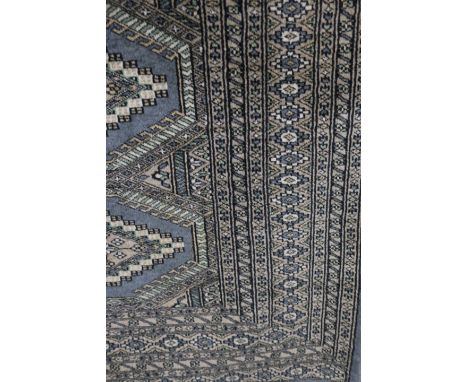 A BELGIAN WOOL RUG the light blue and grey ground with central serated panels within a conforming border  170cm x 130cm