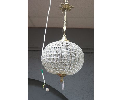 A BRASS FRAMED CENTRE LIGHT with circular open bead work and glass mounted shade