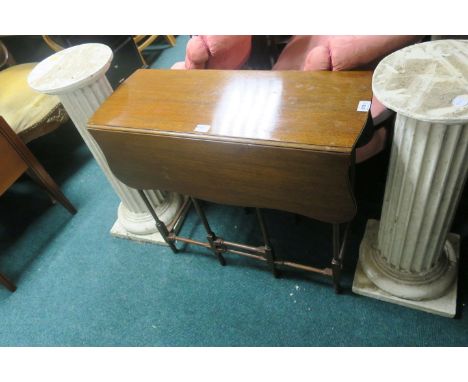 A LATE 19TH CENTURY MAHOGANY DROP LEAF TABLE the butterfly sides raised on ring turned and block end gate leg supports 68cm x