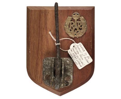 * WWII Relic. Remains of a rudder from a Hawker Hurricane, mounted on a wooden shield with brass RAF cap badge, with a label 