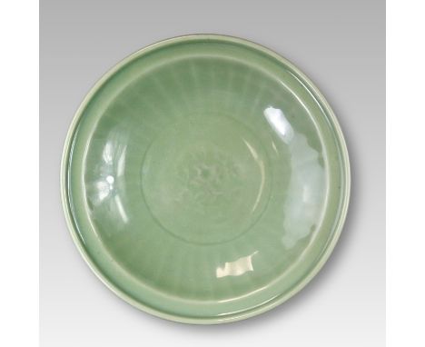 the shallow rounded sides rising from a short tapering foot to a everted lipped rim, moulded to the interior with a foliate m