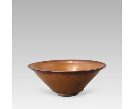 potted in conical shape from slightly splayed foot to everted rim, covered overall in a brown glaze stopping short above the 