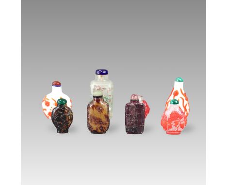 including an interior painted bottle with chrysanthemums, four red overlay bottles, two in carved horn, and a purple tourmali