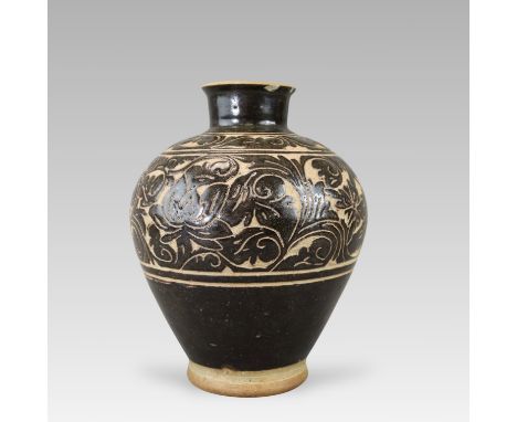 boldly carved through the dark glaze to the buff body with two bands of leafy and peony scroll, all below a tall splayed neck