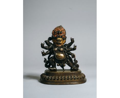 the wrathful manifestation of Avalokitesvara, finely modelled in dark bronze, with three wrathful heads, each with three fier