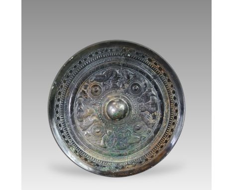 with the central knob set within a small circle of dots, and surrounded by seated deities, mythical beasts and four pointed n