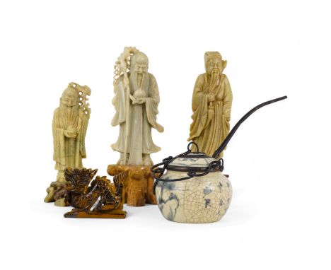 A 20th century carved soapstone figure of an immortal - 16cm high, together with two similar, a blue and white ceramic opium 