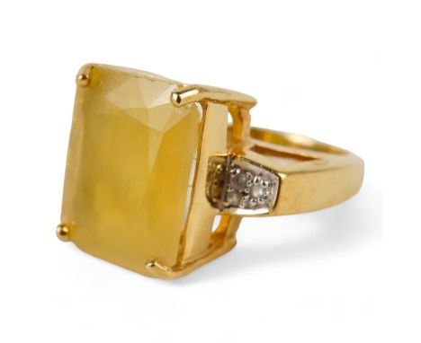 An 18ct gold opal and diamond set ring - rectangular cut stone in a claw setting with diamond shoulders, size N, 9.2g