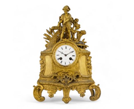 A late 19th century French gilt metal mantel clock - cast with a young fisherman, the white enamel dial set out with Roman nu