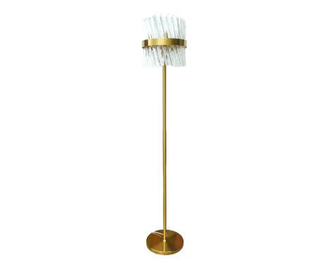 A contemporary brass standard lamp - the shade in the form of profiled clear acrylic shards, height 67cm.