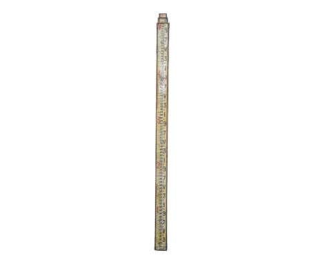 An early 20th century survey staff - mahogany with brass fittings, with a white painted scale set out in imperial measurement