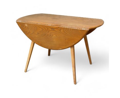 An Ercol beech and elm drop-leaf dining table - the oval top above splayed square tapering legs, 125 x 105 x 73cm.