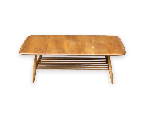 An Ercol beech and elm coffee table - the rectangular top above tapering round legs joined by a slatted undertier, 105 x 45 x