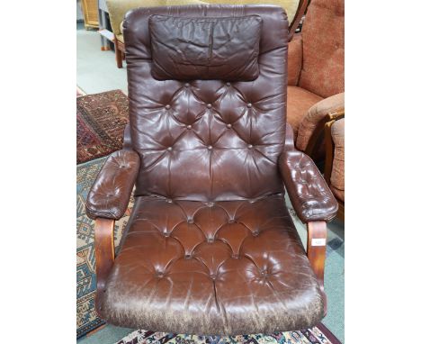 A mid 20th century brown leather button backed upholstered swivel armchair on steel base, 92cm high x 75cm wide x 82cm deep C
