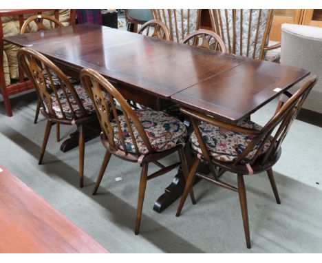 A mid 20th century Ercol elm and beech extending dining table, 75cm high x 115cm long(175cm extended) x 71cm deep and six cha