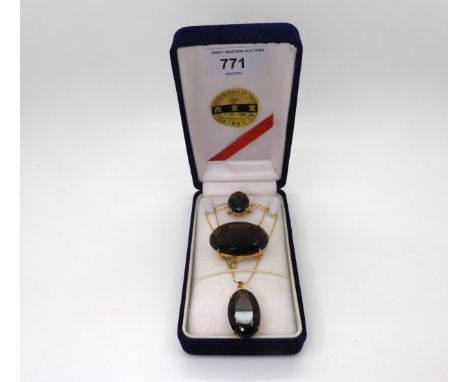 A 14k gold smoky quartz ring, with similar gold plated brooch and pendant, the pendant with a 14k gold chain, weight of the r