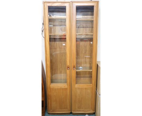 A pair of contemporary Ercol elm and beech glazed tall bookcases, 213cm high x 47cm wide x 31cm deep (2) Condition Report:Ava