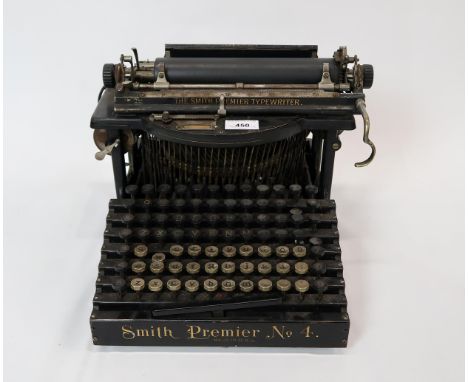 An early-20th century Smith Premier No. 4 dual keyboard typewriter, made in USA, retaining protective cover; together with a 