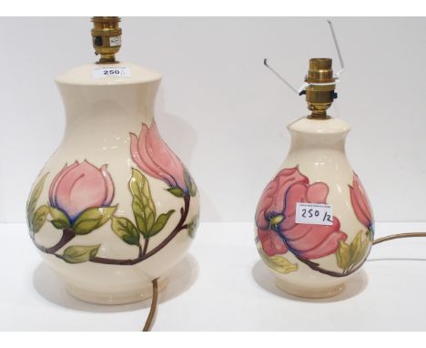 A large Moorcroft Magnolia pattern lamp and another smaller Condition Report:Available upon request