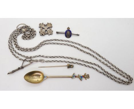 A white metal long guard chain, with attached whip pendant with hoof terminal, a silver gilt spoon with Egyptian themed ename