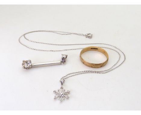 A 9ct white gold diamond set snowflake pendant, length of chain 46cm, a 9ct wedding ring size S1/2, and a 9ct gold cz pendant