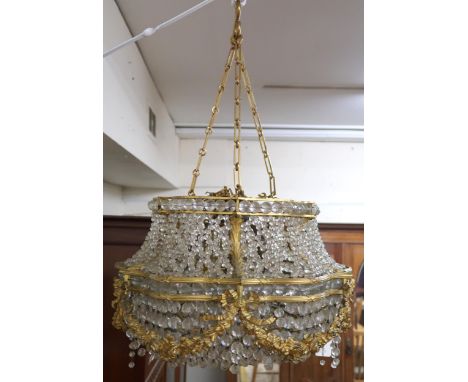 An early 20th century Louis XVI style basket chandelier with cast brass floral swags joined by interwoven glass droplets, 75c