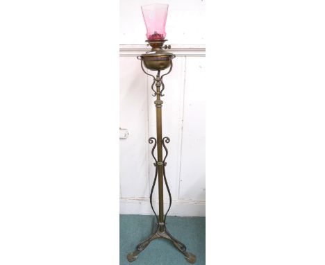 A 19th century brass adjustable oil standard lamp on tripod base, 158cm high Condition Report:Available upon request