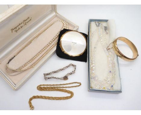 A jewellery box containing, a silver gate bracelet with heart shaped clasp, a 1/5th 9ct gold with metal core engraved bangle,