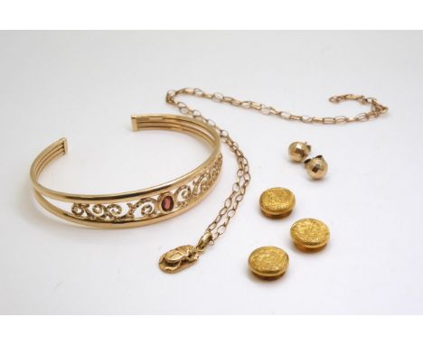 A 9ct gold garnet set cuff style bangle, a bright yellow metal Arabic gold scarab beetle pendant on a 9ct belcher chain, thre
