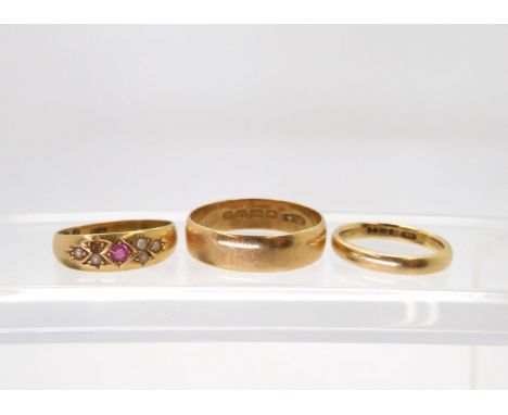 Three 18ct rings, red gem &amp; pearl ring size N, two wedding bands size K, and X, weight together10.5gms Condition Report:A