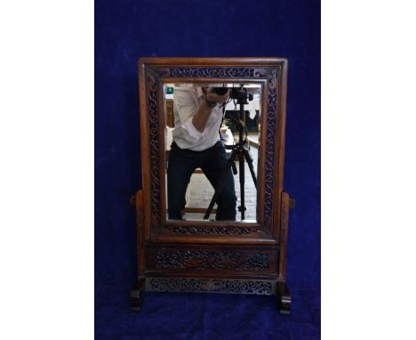 A 19th century mahogany dressing table mirror with pierced scroll carved frame and central bevelled rectangular mirror plate,