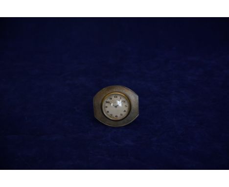 A George V silver desk clock with engine turned exterior, the clock face with Arabic numerals, pierced moon phase hands and m
