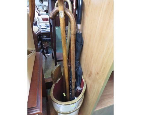 PAINTED WOODEN UMBRELLA AND STICK STAND WITH CONTENT OF WALKING STICKS AND UMBRELLA.