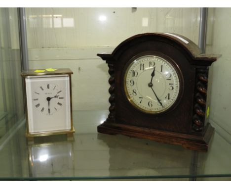 AN OAK MOUNTED MANTEL CLOCK WITH FRENCH MOVEMENT, TOGETHER WITH A HEALS OF LONDON QUARTZ MANTEL CLOCK.