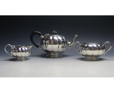 A George V silver three-piece  tea service, maker Francis Higgins &amp; Sons Ltd, London, 1924, of squat melon-shaped outline