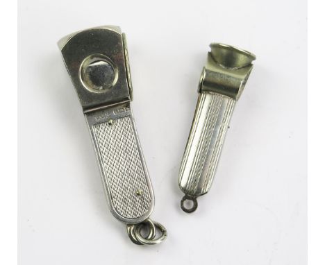 An Elizabeth II silver framed cigar cutter, maker W M Ltd, Birmingham, 1971, with engine turned decoration, 6cm long, togethe