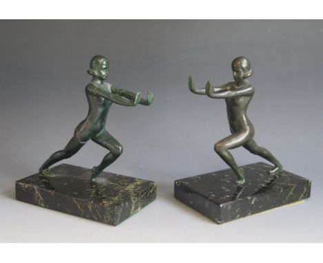 A pair of Art Deco period painted spelter bookends, modelled as nude females, raised on rectangular marble bases, 19cm high. 