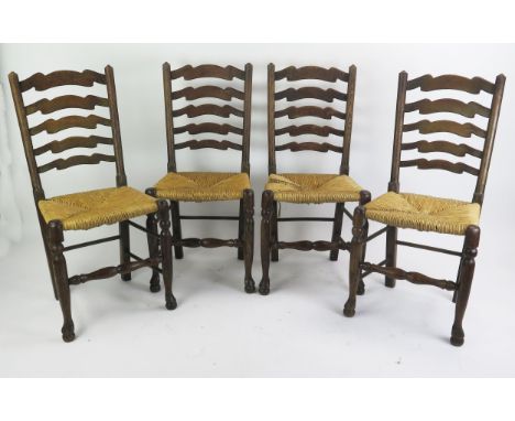 A set of four elm ladder back dining chairs, with sisal seats raised on turned legs linked by stretchers. (4). 