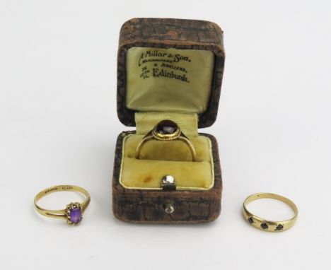 A 9ct Gold and Amethyst Ring (8.1x5.8mm head, hallmarked, size M.5, 1.39g), a 9ct gold and cabochon garnet ring (11.6x9.5mm h