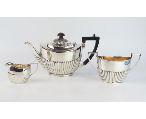 A matched three-piece tea service, various makers and dates, of oval outline with half reeded decoration, total weight of sil