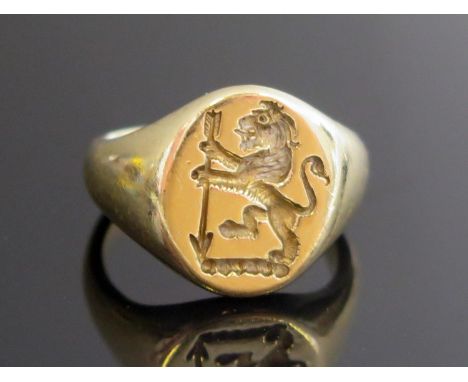 A 9ct Gold Signet Ring engraved with a lion rampant supporting an arrow in pale point downwards (Egerton family), size J.5, h