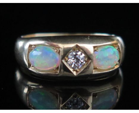 An Antique Opal and Diamond Gypsy Style Ring, c. 6.1x3.9mm singlet specimens with a c. 3mmold cut to the centre, stamped 18, 