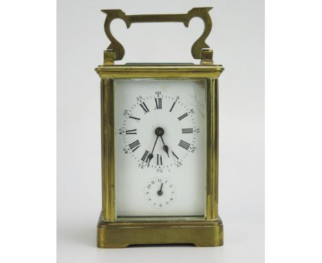 A lacquered brass carriage clock, the 6cm Roman dial with subsidiary alarm dial, the movement with platform lever escapement,