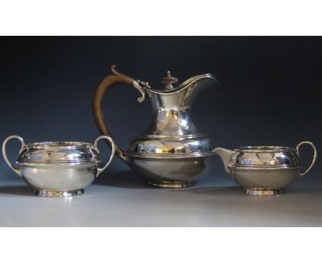 A George V silver three-piece tea service, maker SWS Smith &amp; Co, Birmingham, 1916, of squat circular form with reeded gir