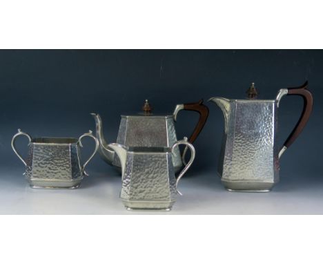 An Abbey beaten pewter four piece tea service includes teapot, hot water jug, sugar basin and cream jug. (4). 