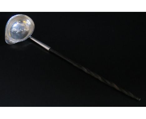 A George III silver toddy ladle, makers mark worn possibly T.S, London, 1779, monogrammed, mounted on a baline spiral twist h