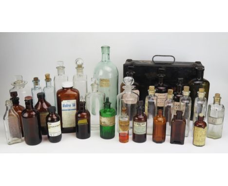 A collection of clear and brown glass pharmaceutical bottles, medicine bottles, metal first aid box etc. 