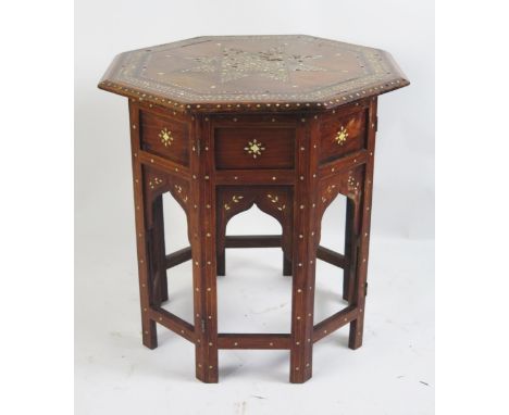 An Indian hard wood, ebony and bone inlaid tiffin table of octagonal outline, the top with inlaid stellar on a folding panell